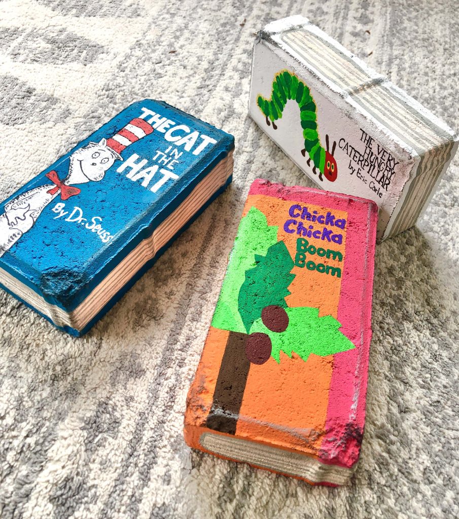 Three bricks painted to look like children's books. How To Paint Bricks to Look Like Books