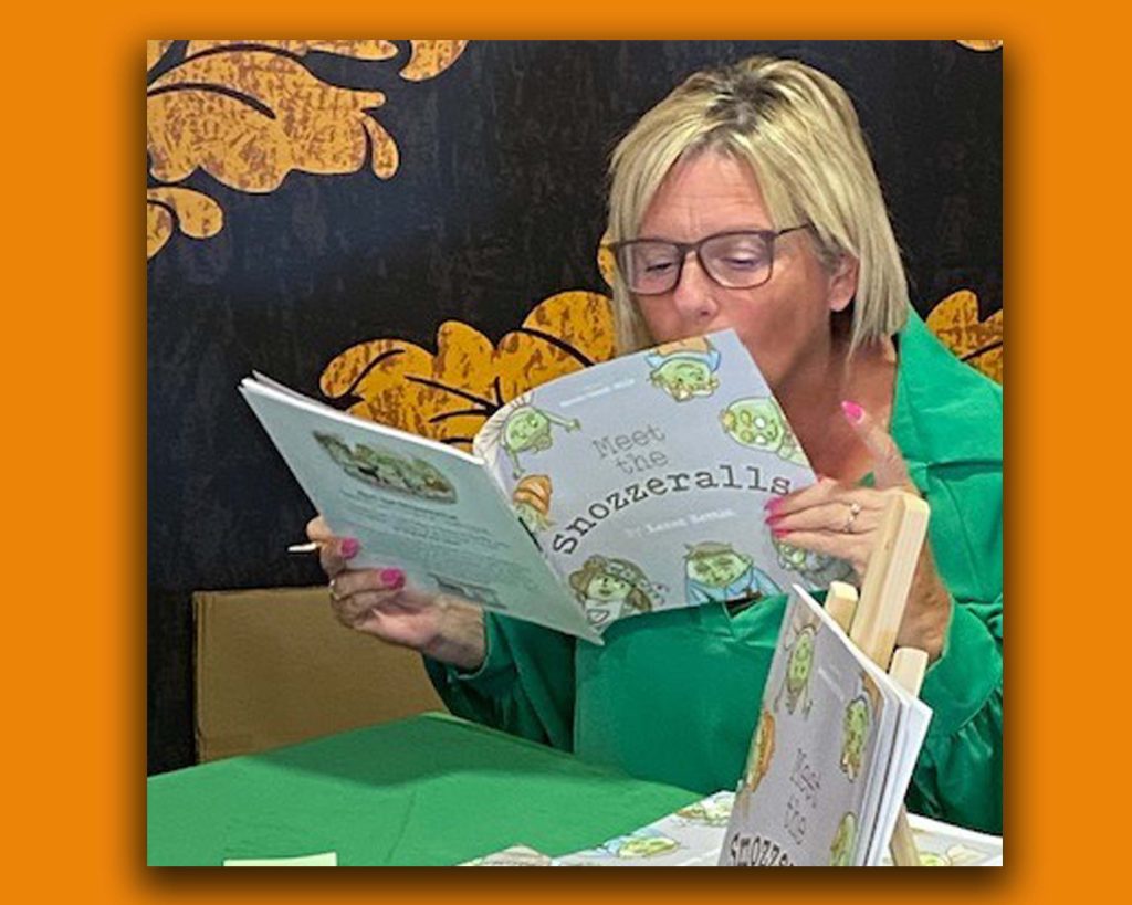 Picture of author Karen Henton flipping through her children's picture book. Author Karen Henton Talks Character Creation and Picture Book Marketing